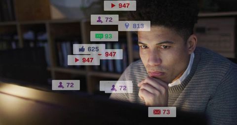 Contemplative man working late at home desk with streaming notifications and analytics