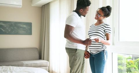 Joyful Expecting Couple Viewing Ultrasound in Sunlit Room