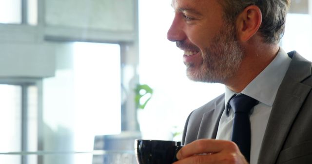Smiling Businessman Holding Coffee Cup in Office - Download Free Stock Images Pikwizard.com