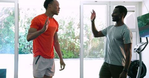 Individuals bonding during home workout routine with kettlebells