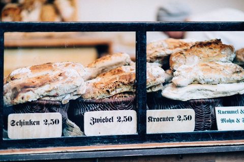 Freshly baked breads displayed with price tags at market stall