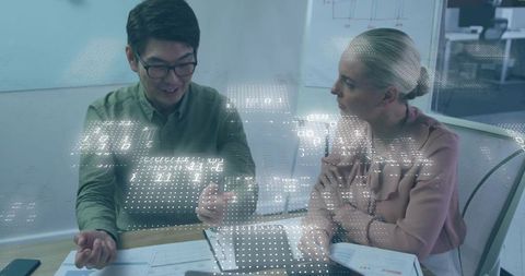 Colleagues Collaborating on Data in Modern Office with Digital Interface