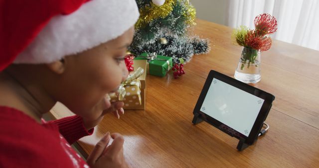 Young woman video calling Christmas loved ones tablet festive decorations - Download Free Stock Images Pikwizard.com