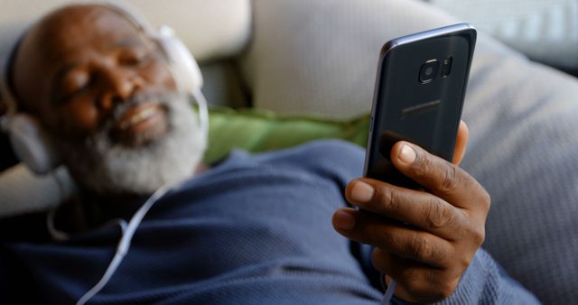 Older African American Man Relaxing on Couch Listening to Music - Download Free Stock Images Pikwizard.com