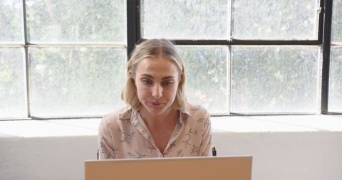 Focused Businesswoman Concentrating on Work with Laptop in Bright Office - Download Free Stock Images Pikwizard.com