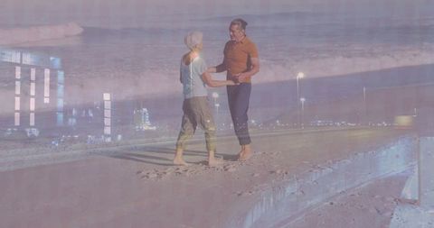 Senior couple enjoying romantic beach walk at twilight