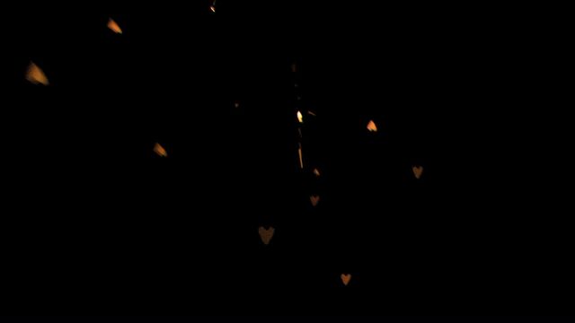 Heart-shaped sparks flying against a black background in slow motion, creating a romantic and expressive effect. Ideal for use in romantic or love-themed projects, Valentine's Day content, abstract art, celebration visuals, or special effects in videos.