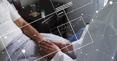 Doctor holding patient hand bedside with digital network overlay conveying compassion