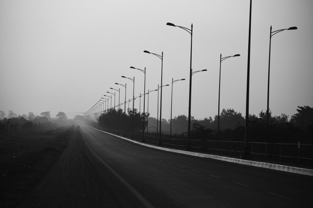 Deserted Highway with Streetlights in Black and White - Download Free Stock Photos Pikwizard.com