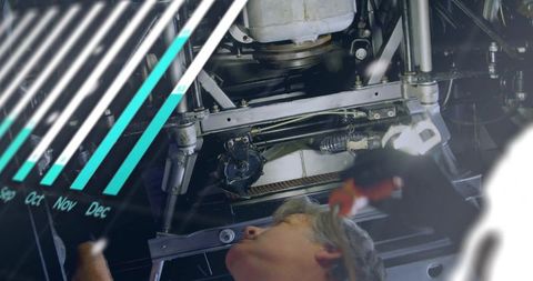 Mechanic inspecting undercarriage with wrench and diagnostic data overlay