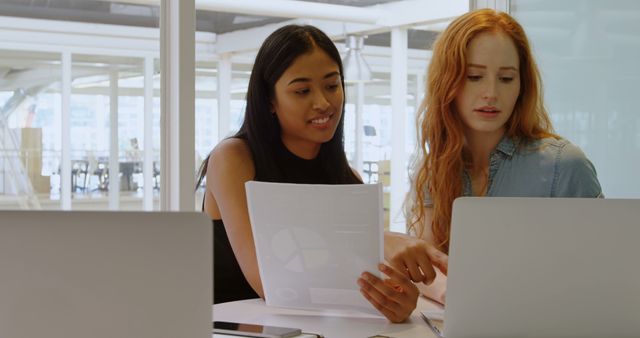 Two Women Collaborating on Project at Office Desk - Download Free Stock Images Pikwizard.com