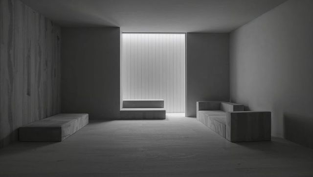 Minimalist gallery with concrete benches and vertical light panel