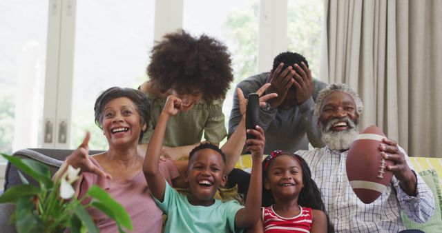 Cheerful family celebrating while watching sports together at home - Download Free Stock Images Pikwizard.com