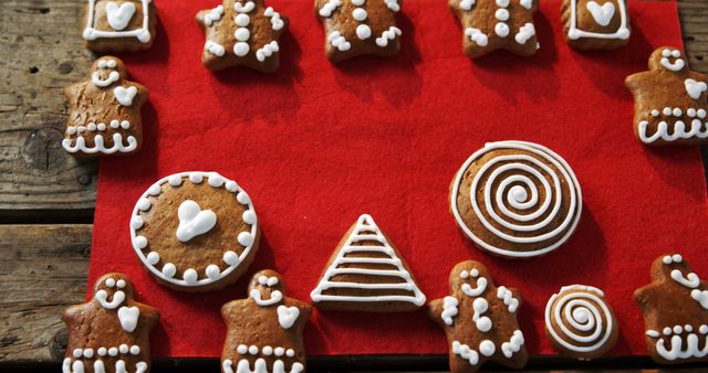 A variety of decorated gingerbread cookies are arranged on a red cloth, with copy space - Download Free Stock Photos Pikwizard.com