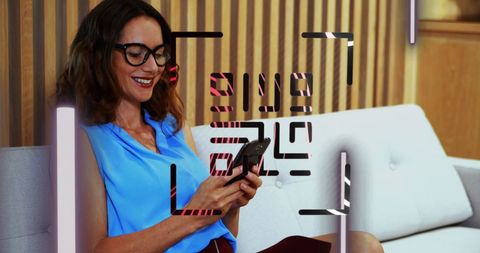Businesswoman Scans QR Code with Smartphone in Modern Office