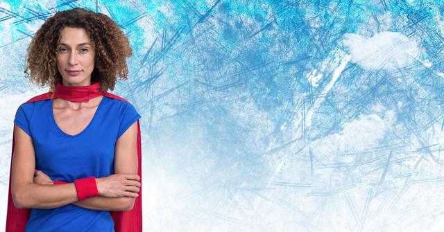 Confident superwoman standing with arms crossed, wearing a blue shirt and red cape, against a digitally generated sky and clouds background. Ideal for use in themes of empowerment, strength, and heroism. Suitable for advertisements, motivational posters, and social media campaigns promoting confidence and determination.