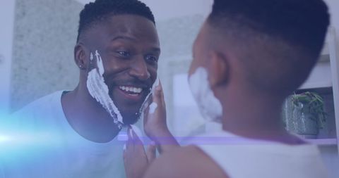 Father and Son Smiling While Shaving Together