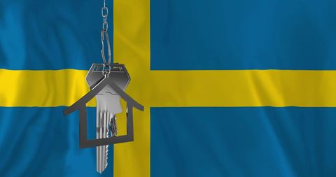 Keys Hanging Over Swedish Flag Symbolizing Homeownership