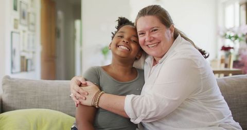 Happy Mother and Daughter Embracing in Cozy Living Room