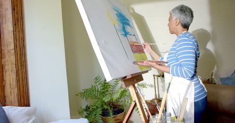 Elderly Woman Painting on Canvas at Home Showing Artistic Expression and Creativity - Download Free Stock Images Pikwizard.com