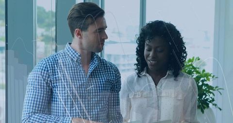 Business Professionals Discussing Data in Modern Office Environment