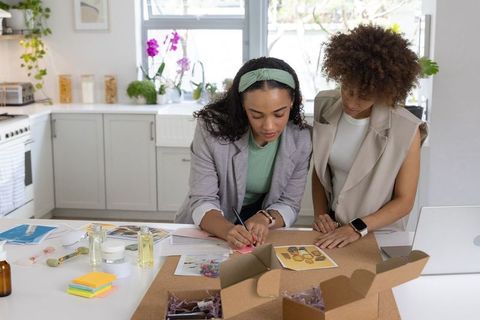 African american women collaborating on small business packaging and product design