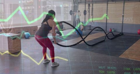 Woman Training with Battle Ropes Amidst Futuristic Data Overlay