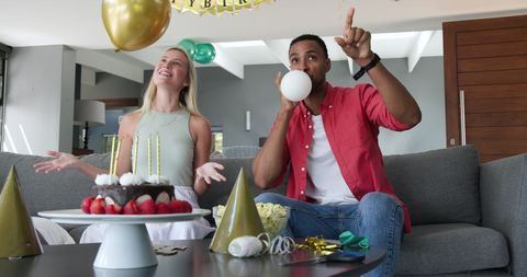 Couple preparing for birthday celebration with joyful enthusiasm