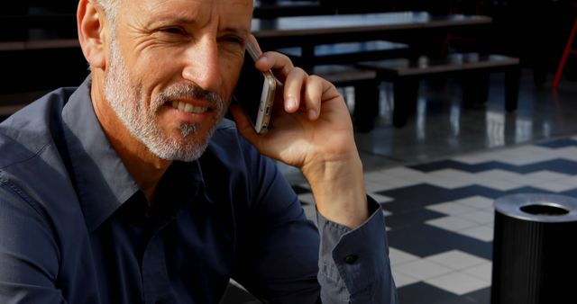 Smiling Mature Man Having Phone Conversation in Modern Environment - Download Free Stock Images Pikwizard.com