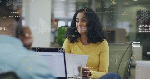 Professional Woman Collaborating in Modern Office with Data Graphics