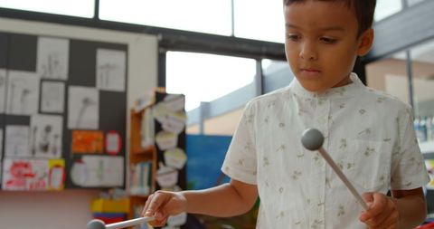 Asian Boy Playing Xylophone in Occupied Classroom - Download Free Stock Images Pikwizard.com