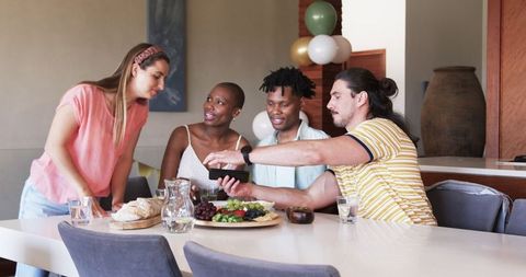 Friends Enjoying Gathering Dining Table with Snacks