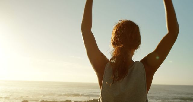 Woman Celebrating Beach Sunrise with Hands Raised - Download Free Stock Images Pikwizard.com