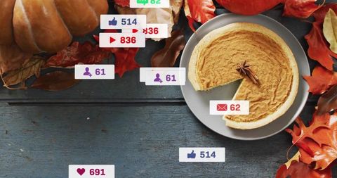 Rustic pumpkin pie flatlay with autumn leaves and social notifications for cozy fall