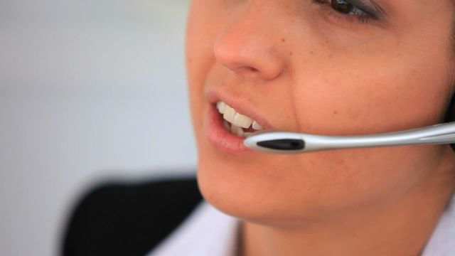 Zoomed view features a friendly businesswoman using a headset, ideal for promoting customer service roles, call center jobs, or office work environments. Excellent for use in marketing, training materials, or illustrating professional interactions.