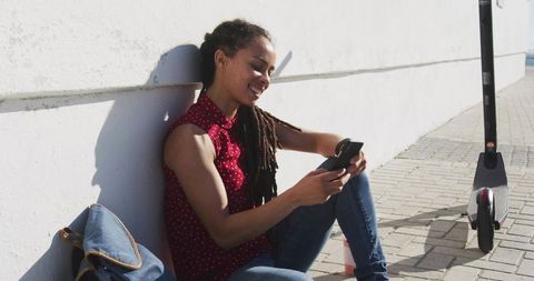 Young Woman Relaxing with Technology Outdoors