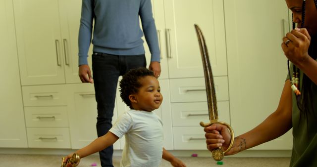 Young Child Playing with Toy Sword Guided by Parent - Download Free Stock Images Pikwizard.com