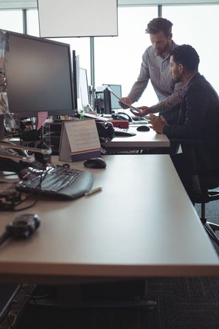 Business Colleagues Collaborating at Desk in Modern Office - Download Free Stock Images Pikwizard.com