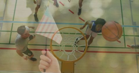Exciting basketball action captured overhead on indoor court