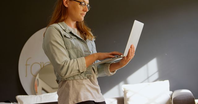 Woman in Casual Attire Working on Laptop at Home - Download Free Stock Images Pikwizard.com