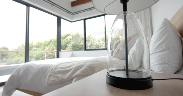 Cozy Minimalist Bedroom with Large Windows and Table Lamp - Download Free Stock Images Pikwizard.com