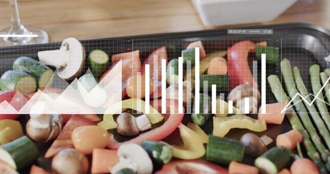 Fresh vegetables on roasting tray showing data charts for food analytics and nutrition
