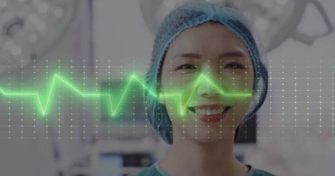 Smiling Female Doctor with Cardiogram Overlay in Hospital - Download Free Stock Images Pikwizard.com