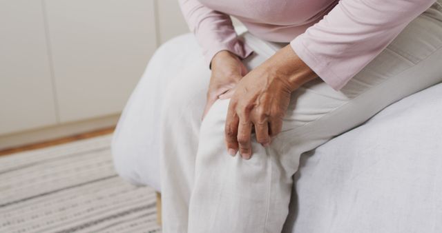 Mid section of african american senior woman holding her leg in pain at home - Download Free Stock Photos Pikwizard.com