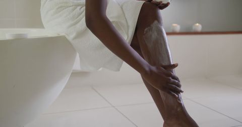 African American Woman Applying Body Balm in Bathroom - Download Free Stock Images Pikwizard.com