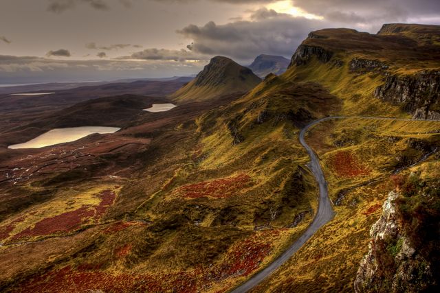 Scenic Highland Road Winding Through Colorful Hills at Sunset - Download Free Stock Photos Pikwizard.com