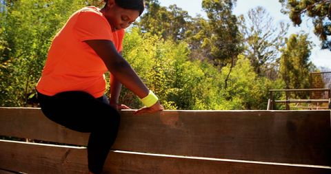 Woman Stretching on Wooden Fence During Outdoor Workout - Download Free Stock Images Pikwizard.com