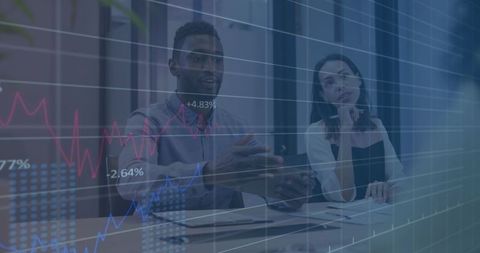 Diverse Business Team Reviewing Financial Data with Charts Overlay