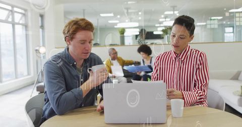 Diverse Colleagues Collaborate in Modern Office with Digital Interface