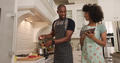 Couple Cooking Together with Digital Tablet Assistance